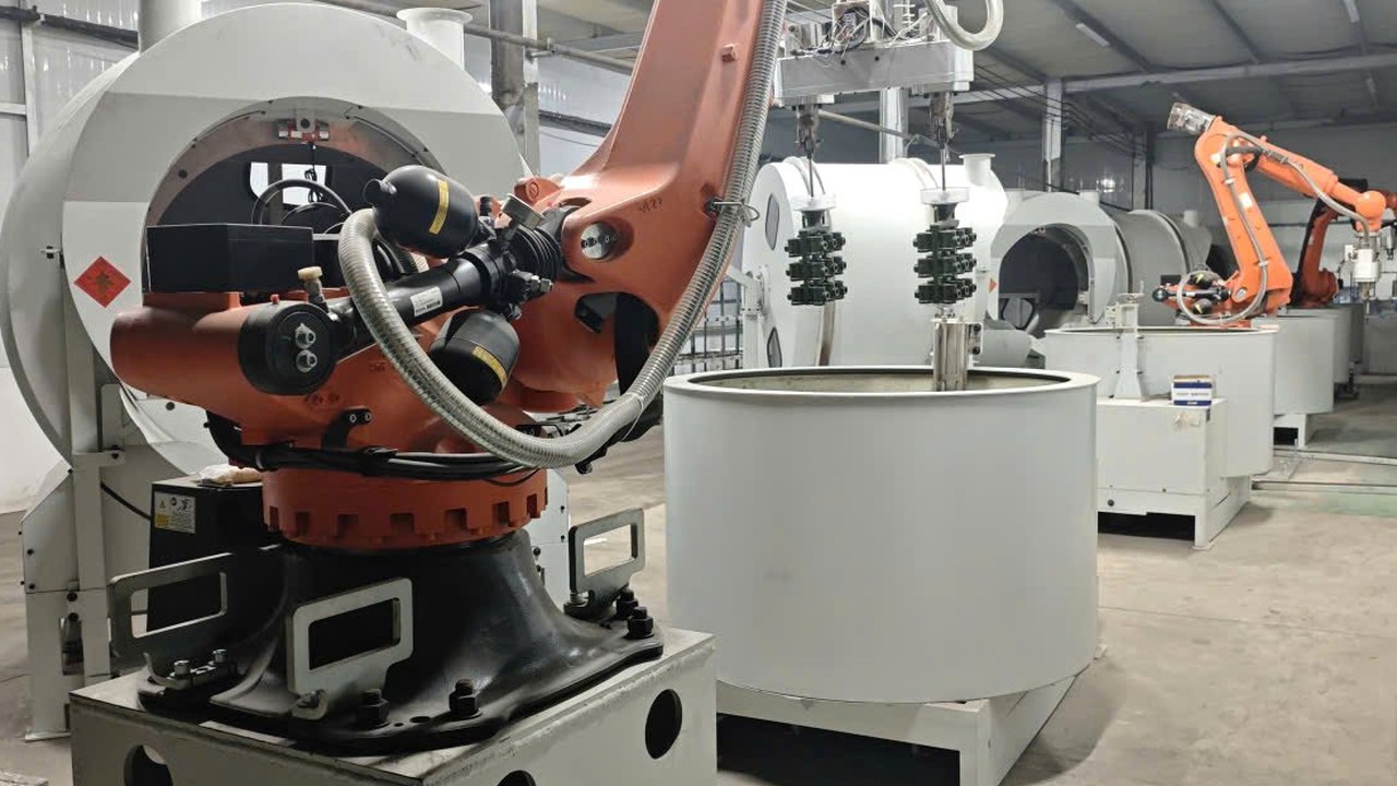 KUKA robot arm dipping a wax tree into the ceramic slurry tank
