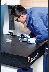 Inspector measuring a part on the CMM
